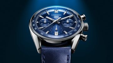 TAG Heuer Carrera Chronograph in Stahl mit blauem Zifferblatt vor dunkelblauem Hintergrund