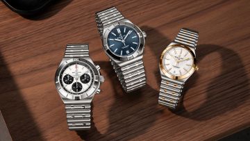 Breitling Chronomat Kollektion mit Chronomat B01 42 Chronograph, Automatic 40 mit blauem Zifferblatt und Automatic 36 in Bicolor auf edler Holzoberfläche.