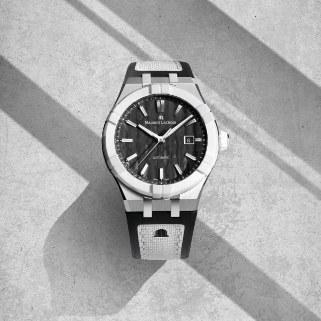 Frontaufnahme Maurice Lacroix AIKONIC Uhr mit schwarzem Zifferblatt und weiß-schwarzem Armband, luxuriöse Automatikuhr aus der Schweiz.