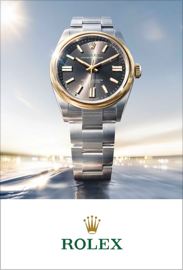Nahaufnahme einer Rolex Oyster Perpetual Armbanduhr mit grauem Zifferblatt und Rolex Logo darunter