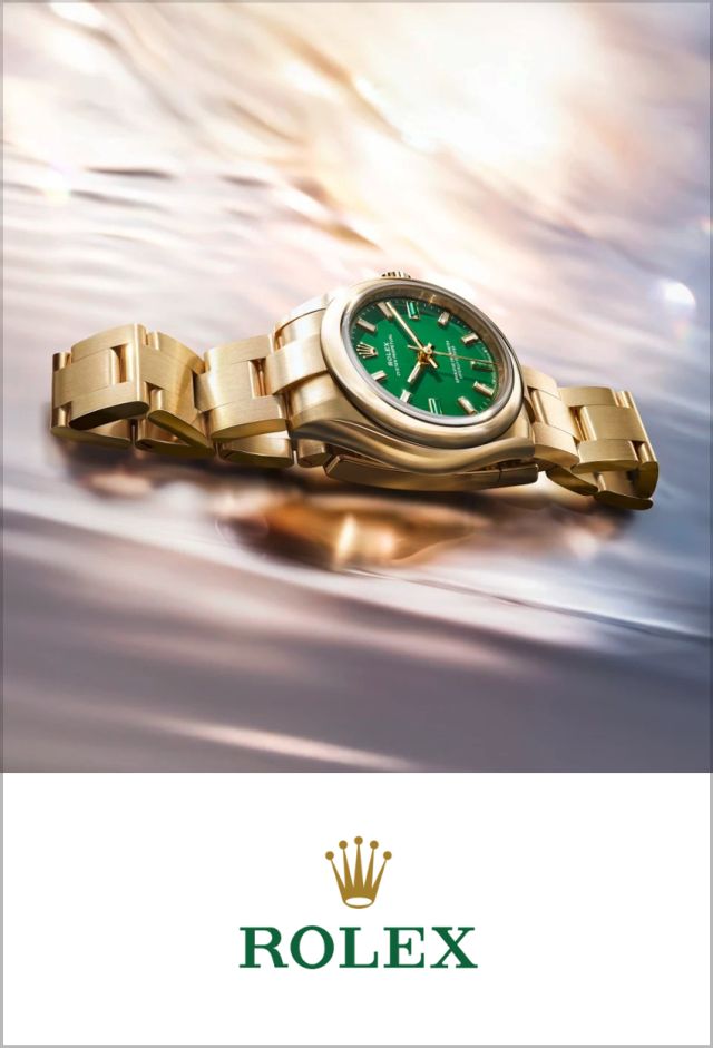 Rolex Datejust 31 Ref. M276208-0002 aus 18 Karat Gelbgold mit grünem Zifferblatt und President-Band, darunter das Rolex Logo auf weißem Hintergrund